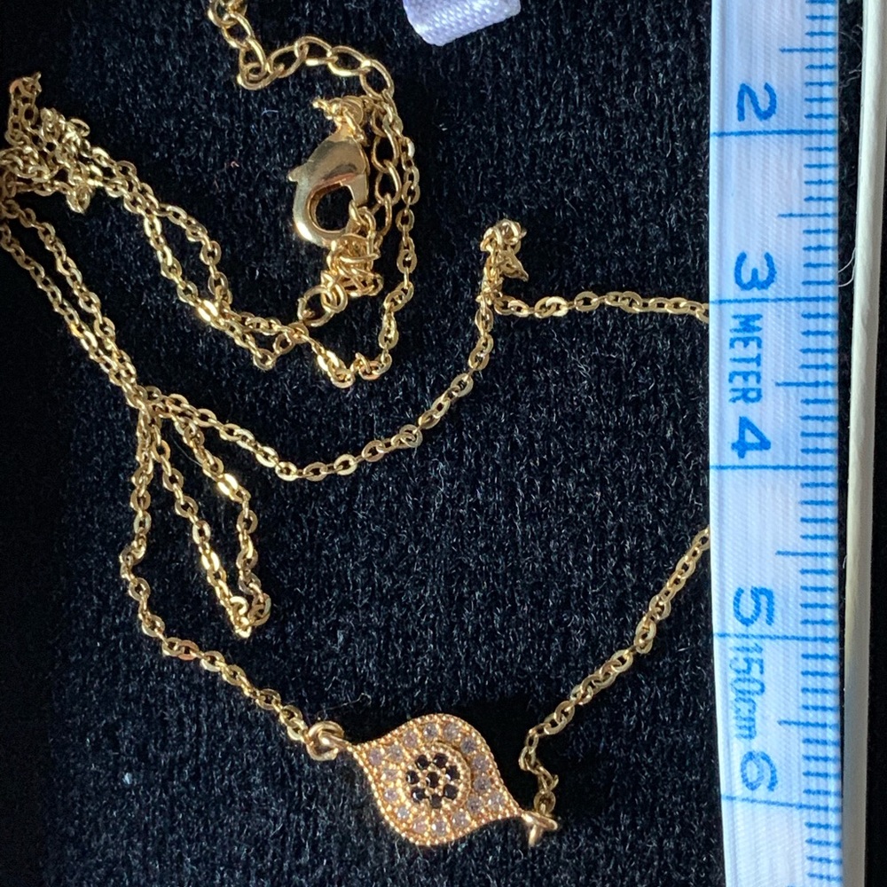 Golden necklace with charm